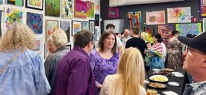 View of guests enjoying an art exhibit opening reception.